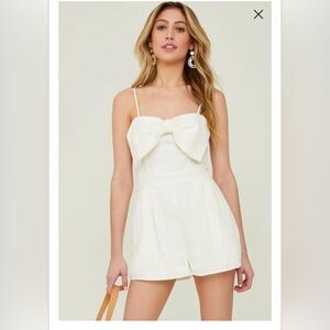 Ivory linen romper with bow from Altar’d State